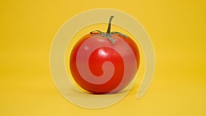 One red Tomato on background colorized yellow