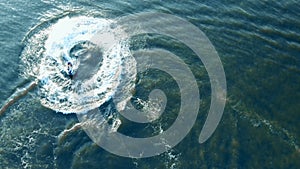 One rider doing stunts on a jet ski, top view. Aerial view from above.