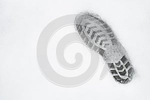 One right foot shoe print on snow, top view, copy space, cloudy