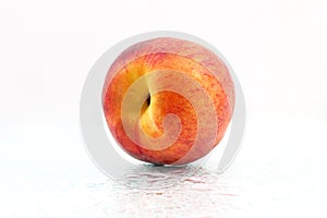 One ripe peach on a white background
