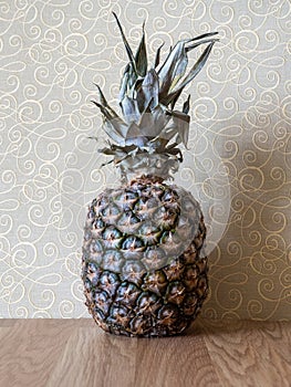 One ripe pineapple on the kitchen table