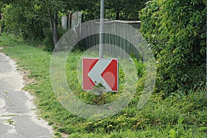 One road sign turning direction with red arrows