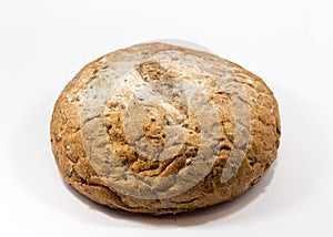 One round grain bread isolated on a white background.Whole fresh wheat and rye small bread with a lot of seeds