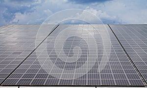 One row of a mega photovoltaic facility with over two megawatt on a roof of a very huge hall photo