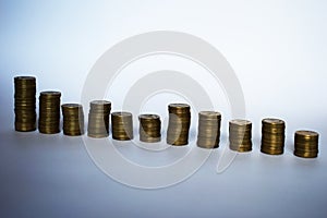 One row of piles of coins. Trends to growth. Silhouettes of coin stacks isolated. Stacks of different heights. Two parallel