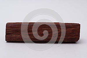 One sandalwood log on white background