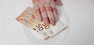 One senior female hand on 50 euro