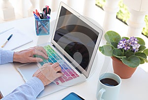 One senior people woman freelance works outdoor in the terrace. Two hands on the laptop. Cup of coffee. Alternative office.