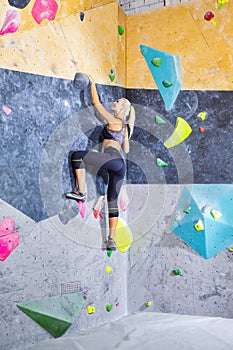 One Sexy Sporty Blond Woman Wihile Busy During Hobby-Bouldering With Well Equipped Training Equipment Climbing Gym