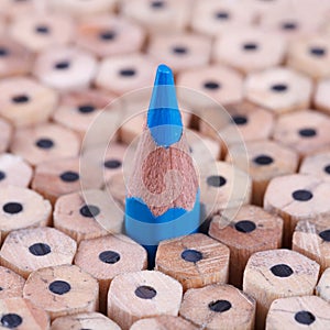One sharpened blue pencil among many ones