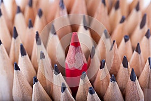 One sharpened red pencil among many ones