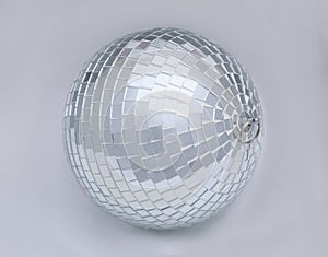 One shiny disco ball on light grey background