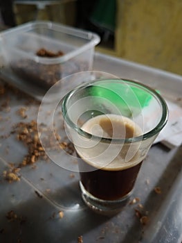 one shot of espresso coffee with pure tobacco in the background from Temanggung, Central Java, Indonesia photo