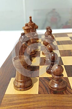 One side black chess piece on chess board ready to play.