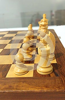 One side chess piece on chess board ready to play.