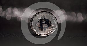 One silver Bitcoin. New virtual currency. Close Up on black background