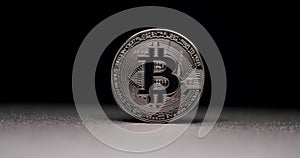 One silver Bitcoin. New virtual currency. Close Up on black background