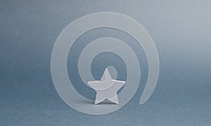 One silver star on a gray background. The concept began the way of business to success, the first steps. The growth of reputation