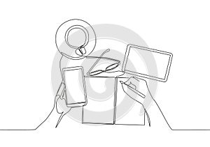 One single line drawing of finger hand touch the smartphone screen with glasses, book, tablet and a cup of coffee on work desk