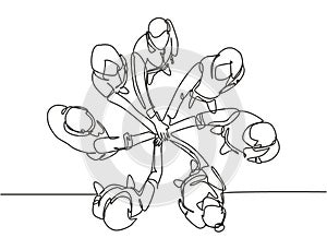 One single line drawing group of young happy business people unite their hands together to form a circle shape symbol, top view.