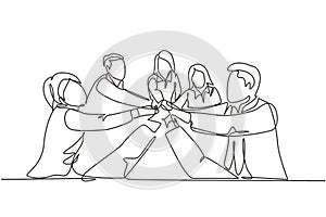 One single line drawing group of young happy male and female business people unite their hands together to form a circle shape.