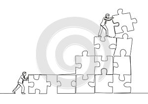 One single line drawing of two young businessman push and arrange puzzle pieces to build a strong building. Business teamwork