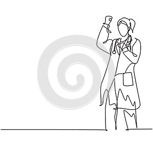 One single line drawing of young happy female doctor fist his hands to the air to celebrate his success treat the patient. Medical