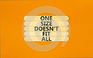 One size does not fit all symbol. Concept words One size does not fit all on wooden stick. Beautiful orange table orange