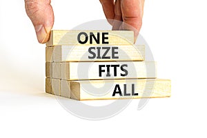 One size fits all symbol. Concept words One size fits all on wooden blocks. Businessman hand. Beautiful white table white photo