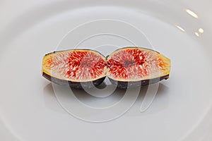 One sliced fig on a plate