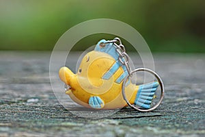 One small blue yellow plastic keychain toy fish