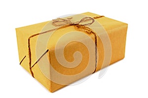 One small brown paper parcel or package tied with string isolated on white