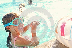 One small girl having fun in outdoor pool