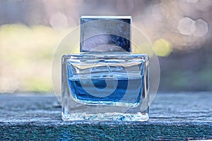 one small glass bottle with blue perfume