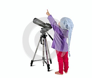 One small little girl looking through spotting scope and pointing up. photo
