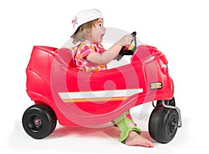 One small little girl playing with toy car.