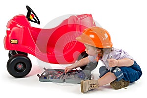 One small little girl playing with toy car.