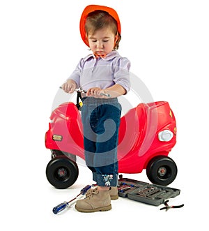 One small little girl repairing toy car.
