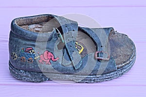 one small old dirty blue leather summer sandal