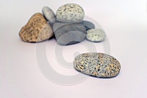 One smooth rock in front of a pile of rocks