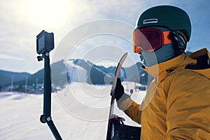 Snowboarder use action camera taking selfie