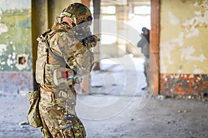 One soldier in combat gear aim at the enemy