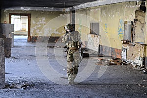 One soldier in combat gear atacking photo