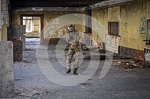 One soldier in combat gear atacking photo