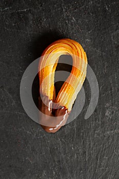 One Spanish churro with chocolate photo