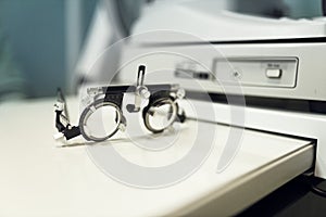 specialised ophthalmologist's spectacles to check vision during an optometric examination of person photo