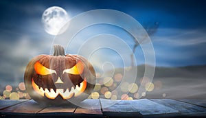 One spooky halloween pumpkin, Jack O Lantern, with an evil face and eyes on a wooden bench, table