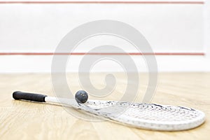 One squash racket and ball