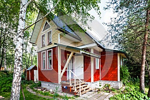 One-storey wooden summerhouse with attic in Russia
