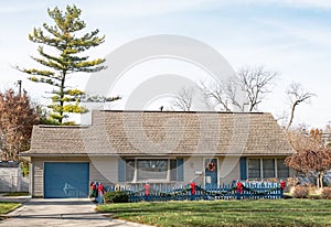 One Story House with Christmas Decor on Blue Picket Fence